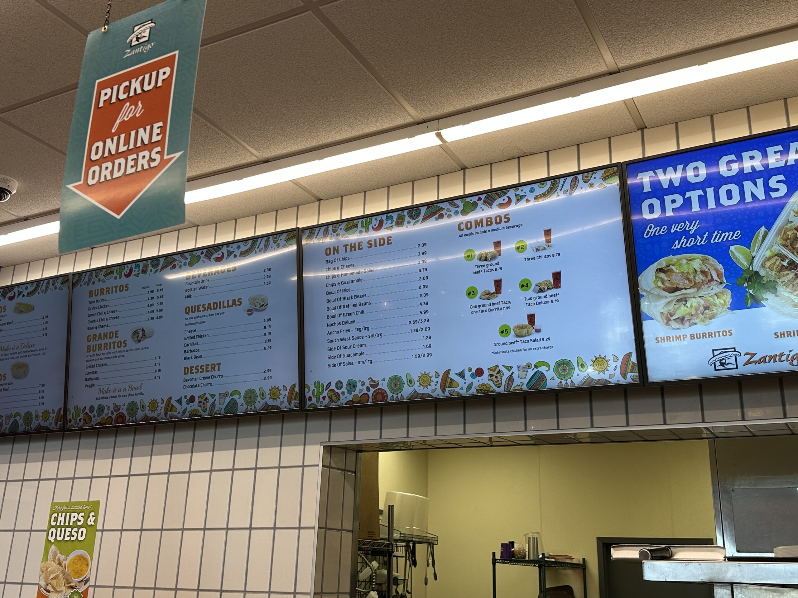 Menu board screens above counter of Woodbury Zantigo