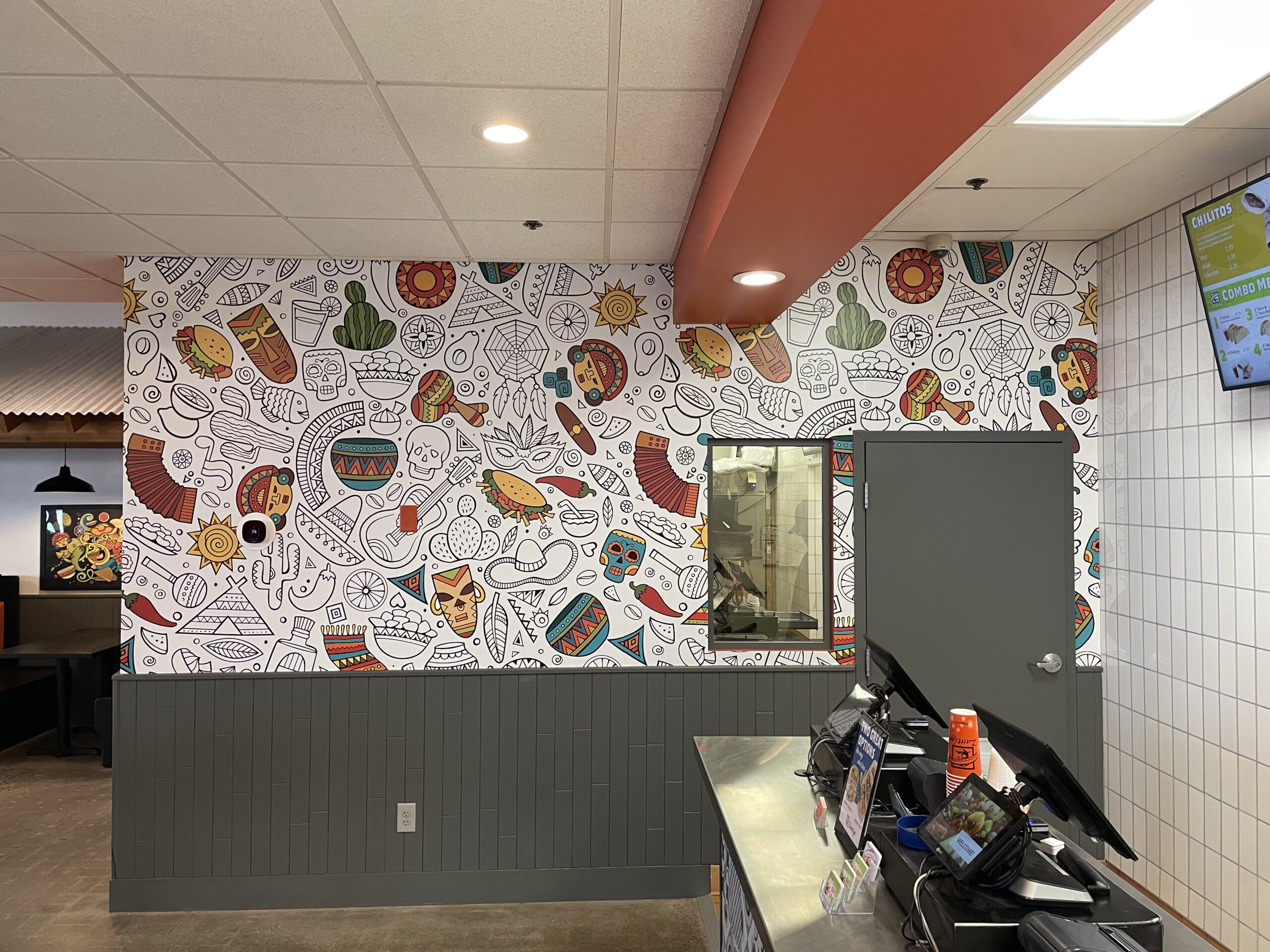 Patterned mural on wall of Woodbury Zantigo next to main counter